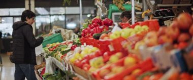 Lisbon, Portugal - Dec. 07, 2019: A senior woman buying fruits and vegetables in the supermarket.