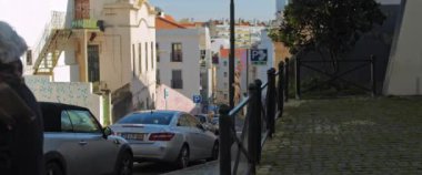Lisbon, Portugal - Dec. 07, 2019: Walking through picturesque narrow streets of Lisbon on a sunny day.
