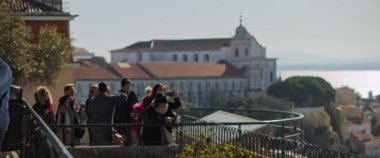 Lisbon, Portugal - Dec. 07, 2019: Tourists taking pictures of a city from a high sightseeing viewpoint