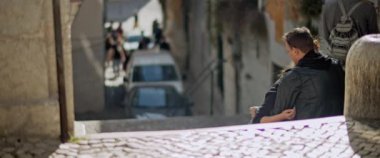 Lisbon, Portugal - Dec. 07, 2019: A couple sitting on top of the stairs during romantic trip to Lisbon.