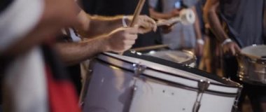 People drumming during a political protest at night. Slow motion.