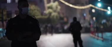 Jerusalem, Israel - August 29, 2020: A policeman in face mask guarding the mass protests in Jerusalem.