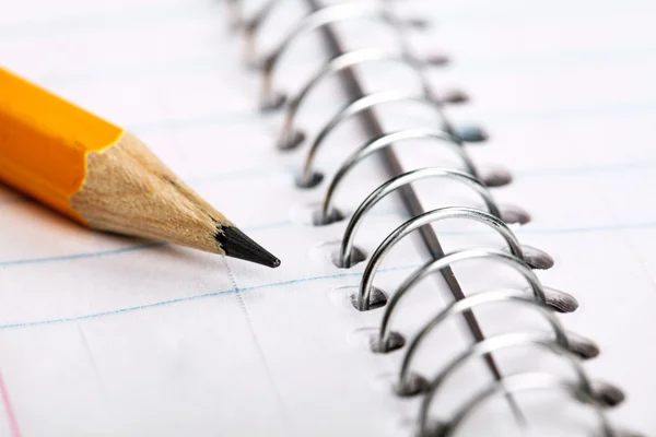 Pencil and a notebook up close Royalty Free Stock Photos