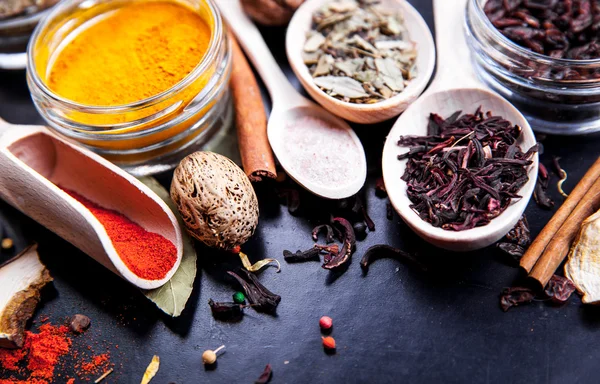 Spices on black background in special jars. Food — Stock Photo, Image