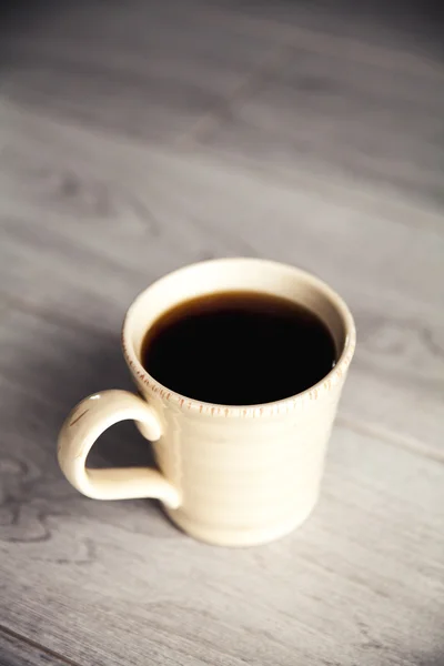 Cup of coffee on gray wood — Stock Photo, Image
