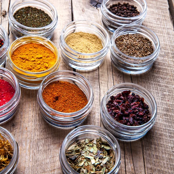 Spices in jars on wooden background. Food — Stock Photo, Image