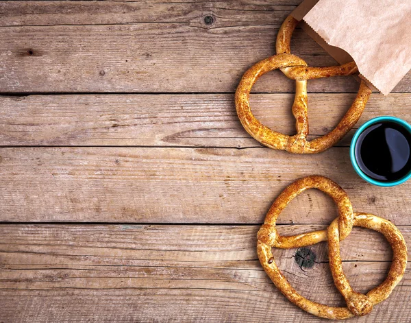 Delicioso desayuno, un pretzel con café sobre fondo de madera . —  Fotos de Stock