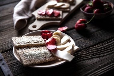 Ahşap arka plan meyveli tost. Çilek, ekmek, tereyağı bir