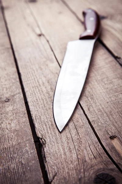 Brown knife on an old kitchen. Cooking, cutting, cooking. On wooden background