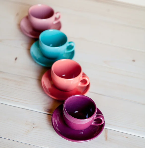 Bright dishes on table on a wooden background