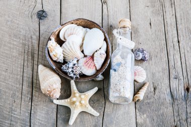 ahşap arka plan şişe bir mesaj ile deniz kabuklarını karede. Deniz sınır
