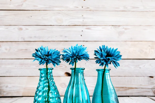 Blue gerbera flower in a vase on wooden background — Stock Photo, Image