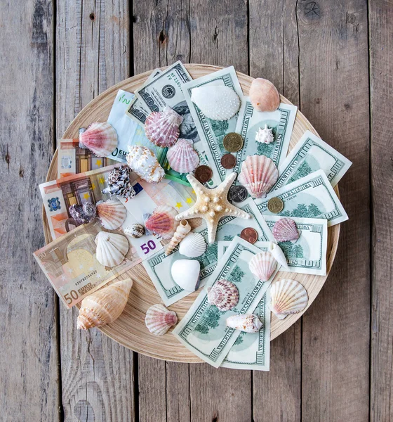 Seashells with money, holiday money — Stock Photo, Image