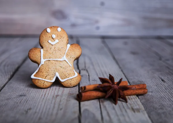 Christmas homemade gingerbread man on wooden background — Stock Photo, Image