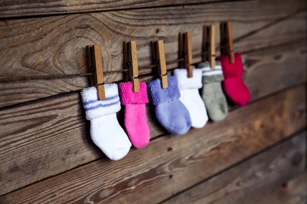 Knitted multicolored socks on a wooden background — Stock Photo, Image