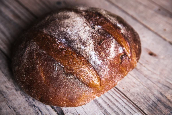 Food, nice rye bread on a wooden background — Stock Photo, Image