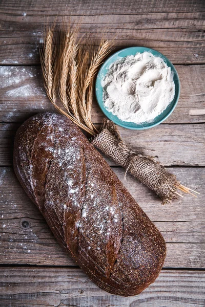 Food. beautiful composition of bread, flour and ears on wooden background — Stock Photo, Image