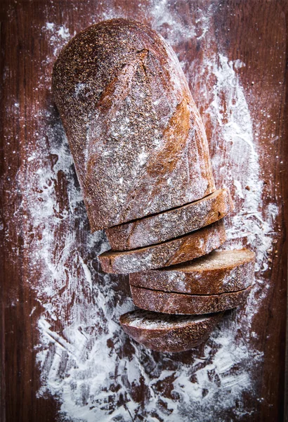 Food. sliced rye bread on a wooden background. Bread flour — Stock Photo, Image