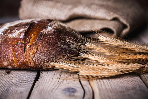 Fresh bread  and wheat on the wooden — Stock Photo, Image