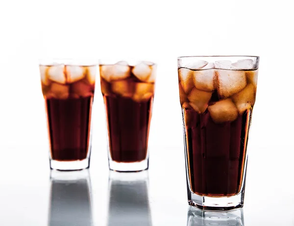 Tres vasos de cola y hielo sobre un fondo blanco. refrescos —  Fotos de Stock