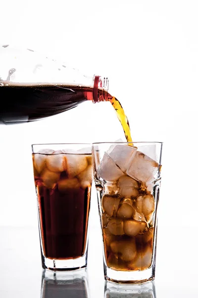 Cola is pouring into glass on white background. soft drinks — Stock Photo, Image