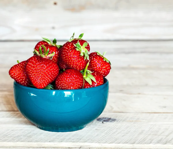 Rote Erdbeeren auf blauem Tonteller. Früchte — Stockfoto