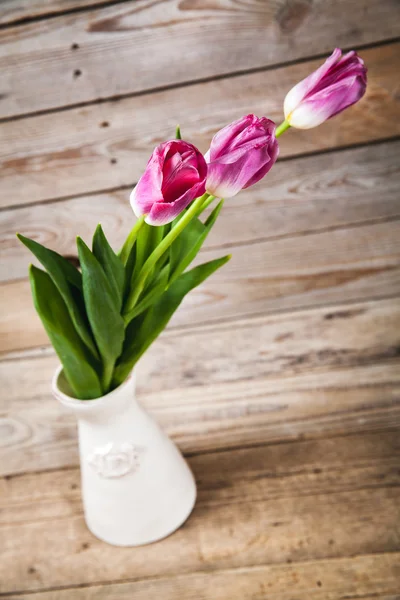 Vase de tulipes naturelles. fleurs sur un fond en bois — Photo
