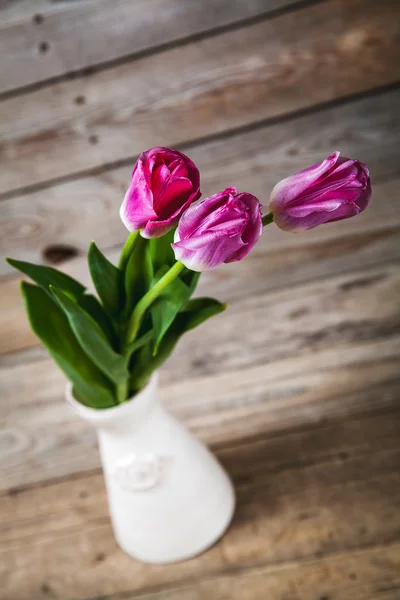 Vase of natural tulips. flowers on a wooden background — Stock Photo, Image