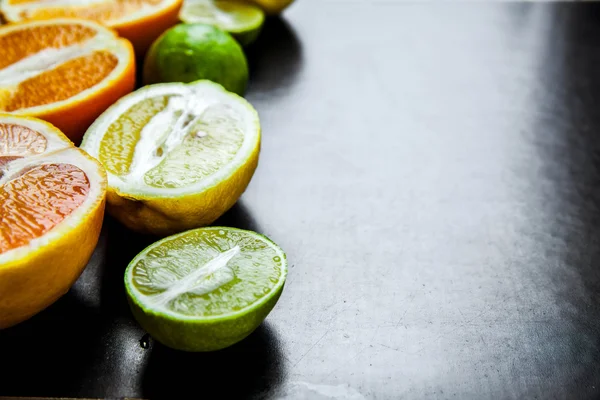 sliced citrus fruit on a black background. food