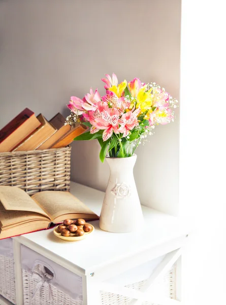 Alstroemeria flowers with cherries and book in vase — Stock Photo, Image