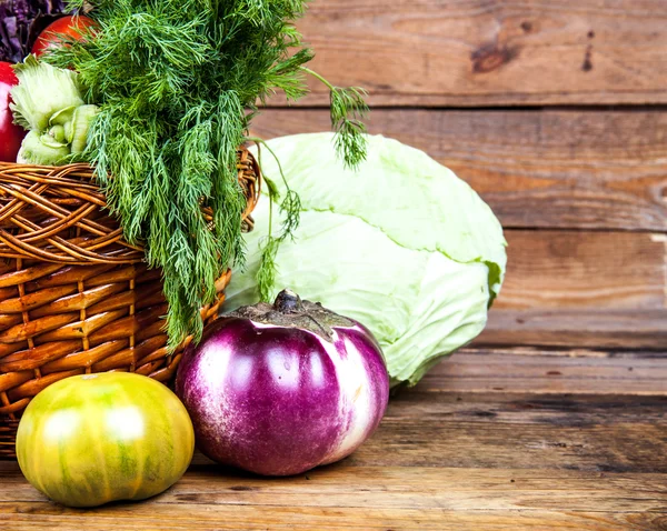 Fresh vegetables in the basket on wooden background — Stock Photo, Image