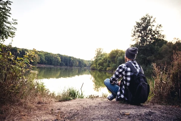 Young Man standing alone outdoor Travel Lifestyle concept with lake