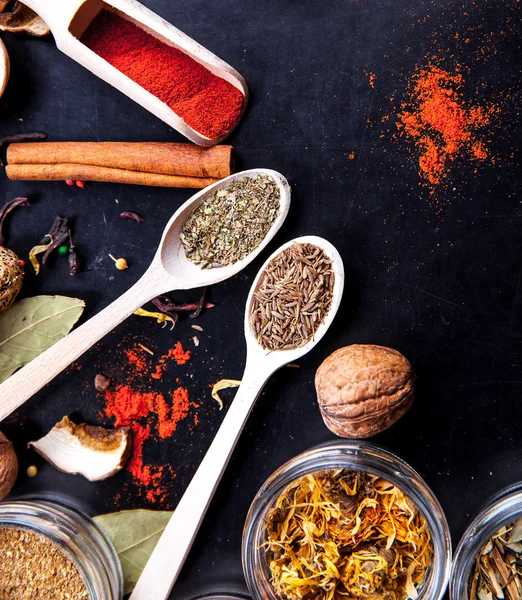 Spices on black background in special jars. Food — Stock Photo, Image