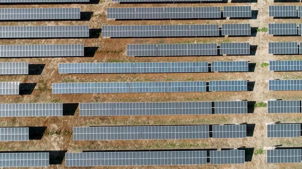 Solar panels farm on the desert aerial view from above. Alternative energy, ecology power conservation concept.