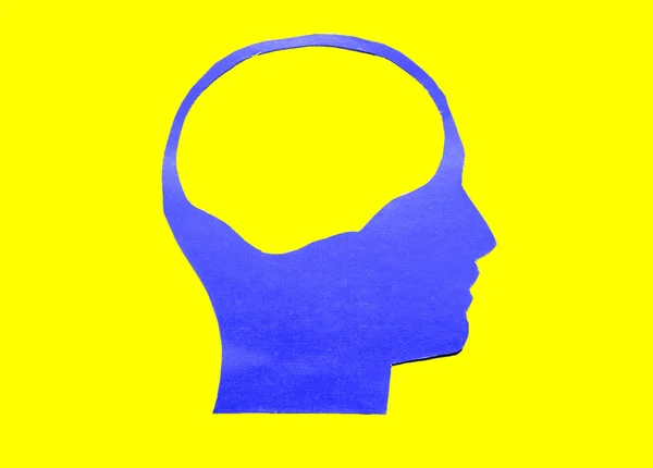 De menselijk hoofd blauw papier met holle ruimte Stockfoto