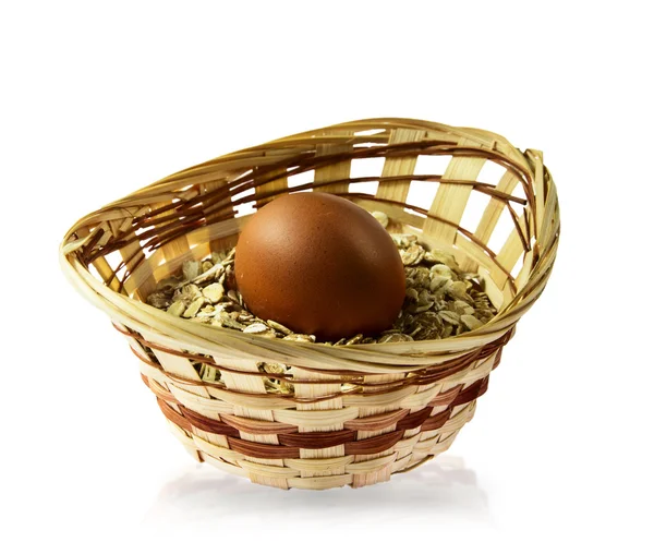 Nice oatmeal porridge and egg in wicker basket — Stock Photo, Image