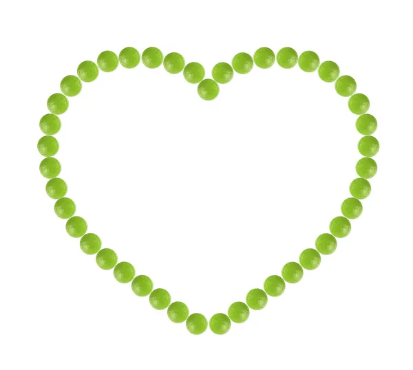 大量的绿色药丸形状在心窗体 — 图库照片