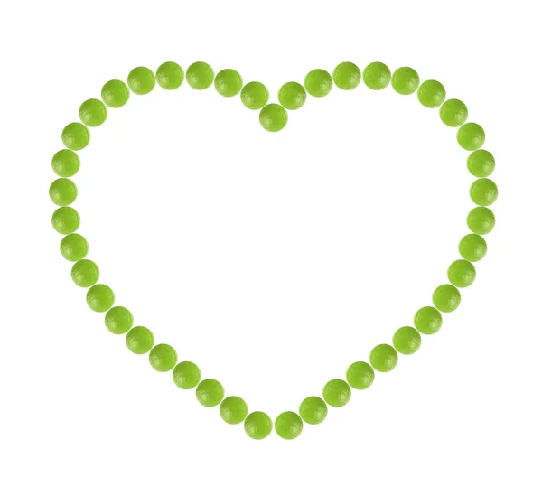 Plenty of green pills shaped in heart form — Stock Photo, Image