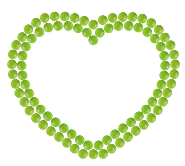 大量的绿色药丸形状在心窗体 — 图库照片