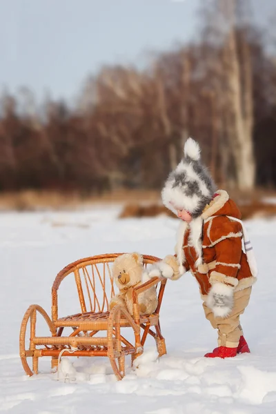 The child holds onto the back of the sled — Stock Photo, Image