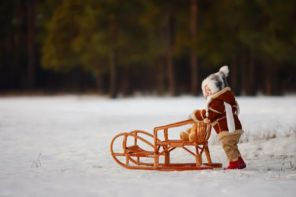 The child pushes the sled — Stock Photo, Image