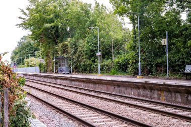 Brundall, Norfolk, UK - July 5 2020. An illustrative editorial photo of the railway line and concrete platform at Brundall Gardens in the Norfolk countryside
