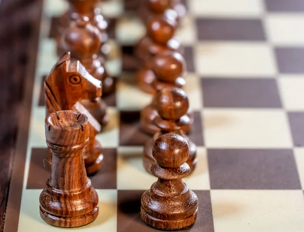 Close up and selective focus on black chess pieces on an electronic chess board