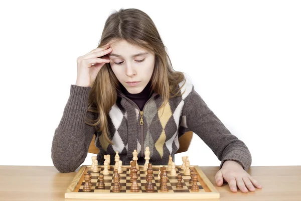 Studio Shot Of Pensive Young Girl Looking Down At Chessboard And Thinking Intensely About Chess Strategy Isolated On White — Stock Photo, Image