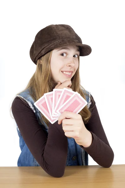 Smiling Cute Girl With Playing Cards Touching Her Chin And Looking Into The Camera Isolated — Stock Photo, Image