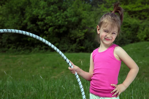 Smiling Little Girl With Hula Hoop Enjoying Beautiful Spring Day In The Park — Stock Photo, Image