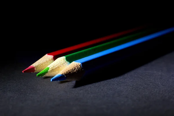 Macro Shot of Red, Green and Blue Sharpened Colorful Pencils Against Black Background — Stock Photo, Image