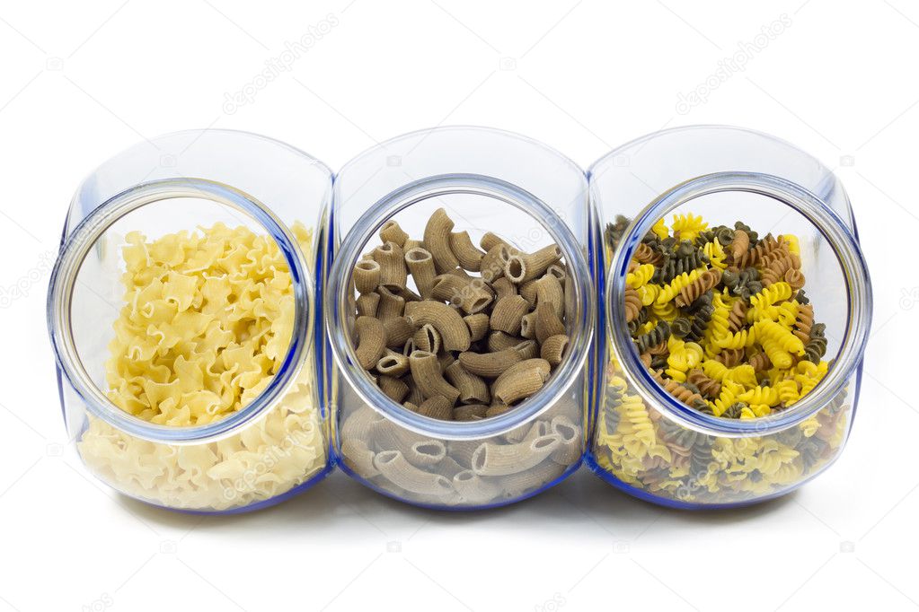 Glass Jars Filled with Various Shapes of Macaroni Isolated on White Background