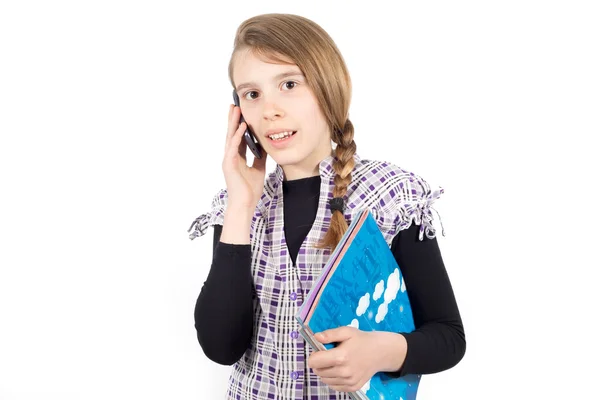 Écolière avec des livres dans sa main parler sur le téléphone portable isolé sur blanc — Photo