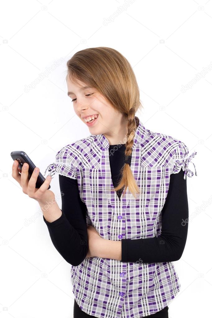 Smiling Girl Reading Funny Message on Her Mobile Phone Isolated on White